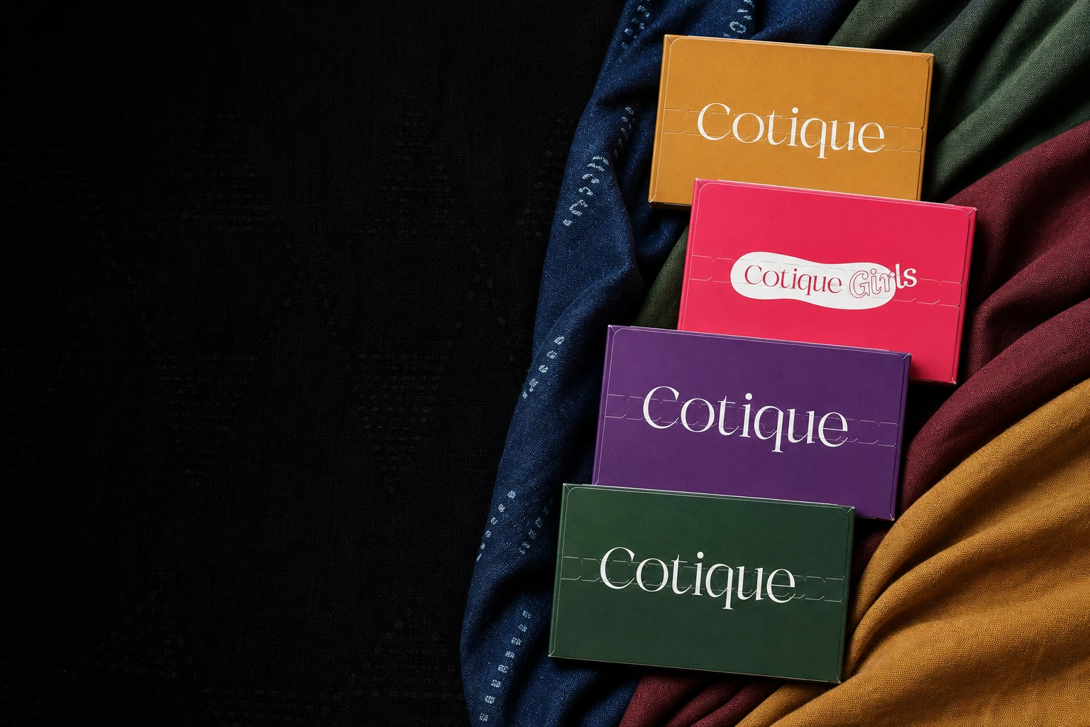 The four Cotique pack tops emerging from layered adire cloth
