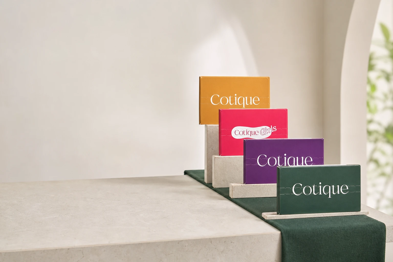 The four Cotique pack tops arranged on a pale stone-coloured counter